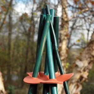 Orange Stretch & Hold connector joining garden stakes to form a plant-support teepee