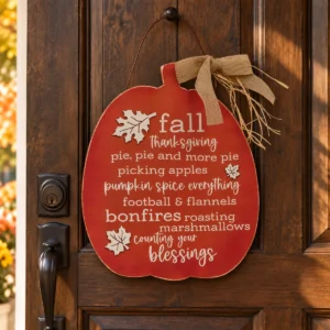 Counting Your Blessings pumpkin sign hanging on a dark wooden farmhouse door