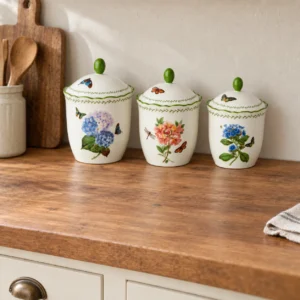 Mirabella floral canister set displayed on a wood counter in a country kitchen